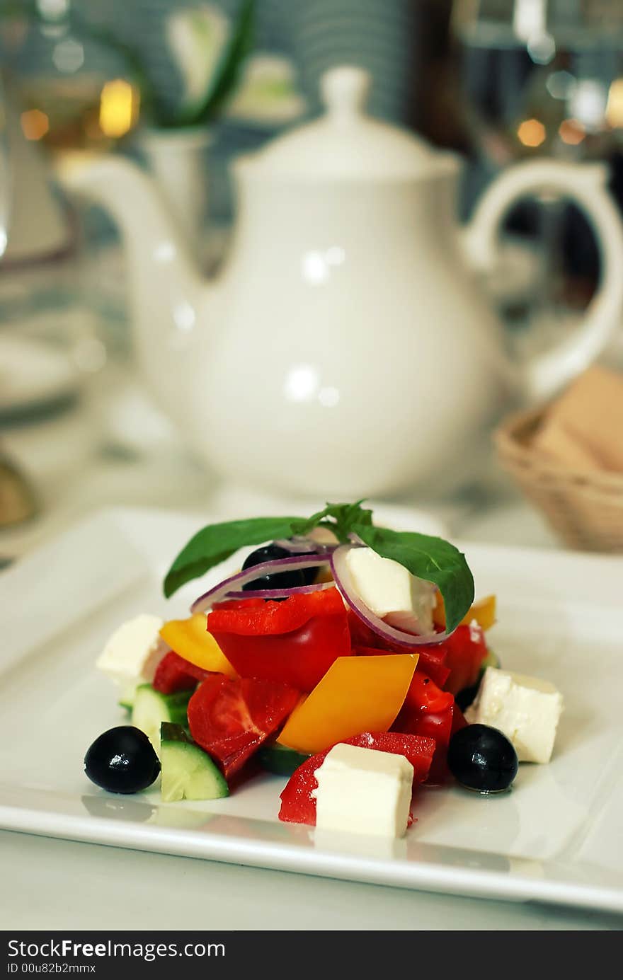 Healthy green salad on white plate in luxury restaurabt. Healthy green salad on white plate in luxury restaurabt