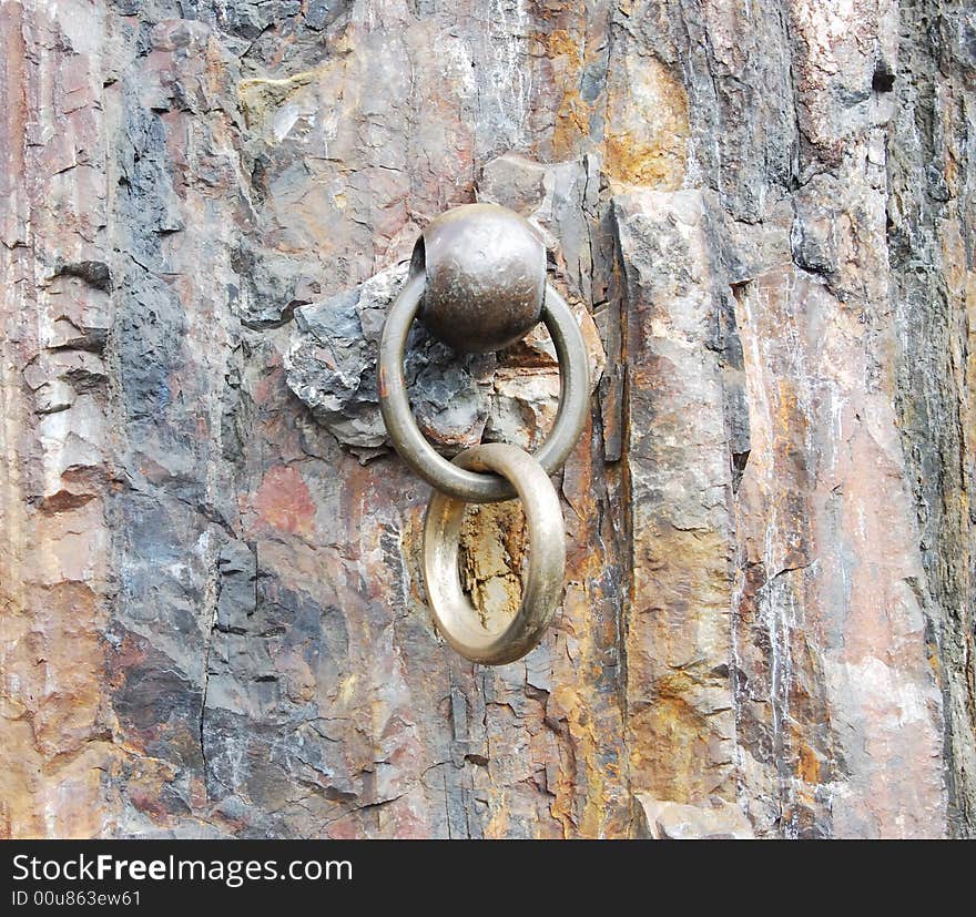 Vintage metallic ring is in a rock