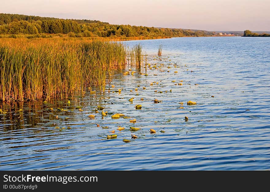 Beautiful and picturesque water landscape in summer - sunset over the river. Beautiful and picturesque water landscape in summer - sunset over the river