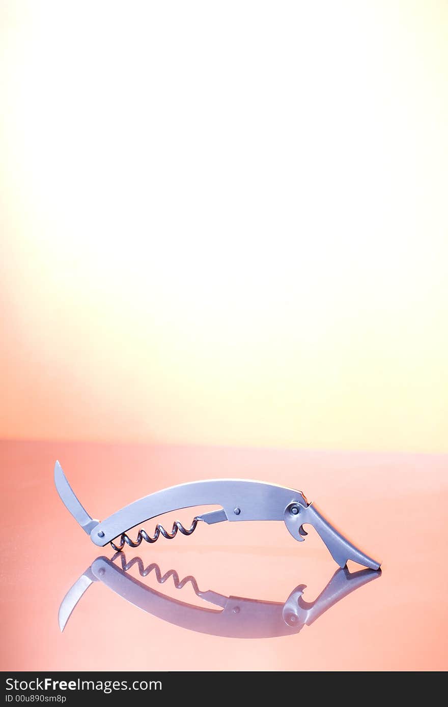 A metal corkscrew on the orange background / copyspace