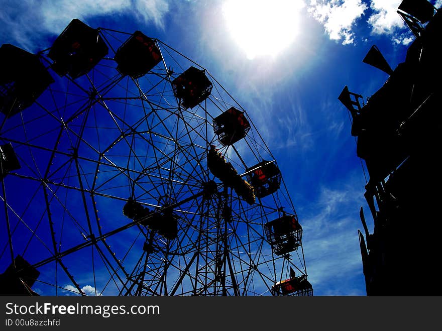 A ferris wheel taken againt a blue background, background has been darkened in CS3. A ferris wheel taken againt a blue background, background has been darkened in CS3