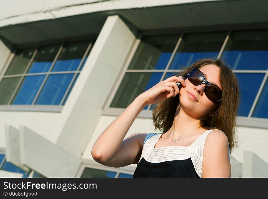 Businesswoman talk to phone on business building