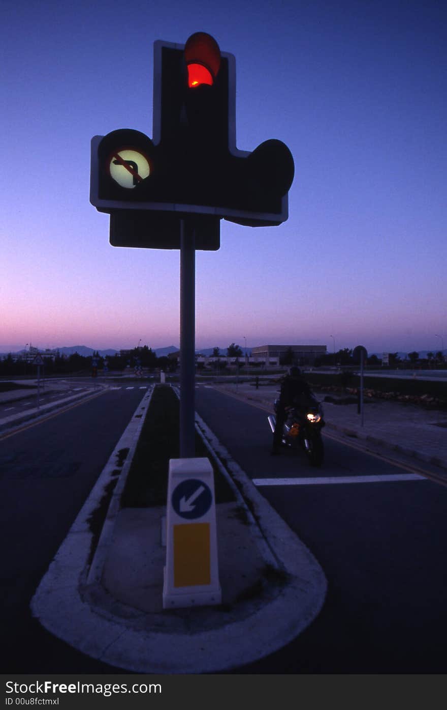 A roadster bike at traffic lights - red light. A roadster bike at traffic lights - red light