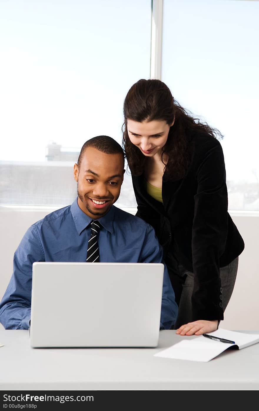 Male and female business partners in a window office. Male and female business partners in a window office