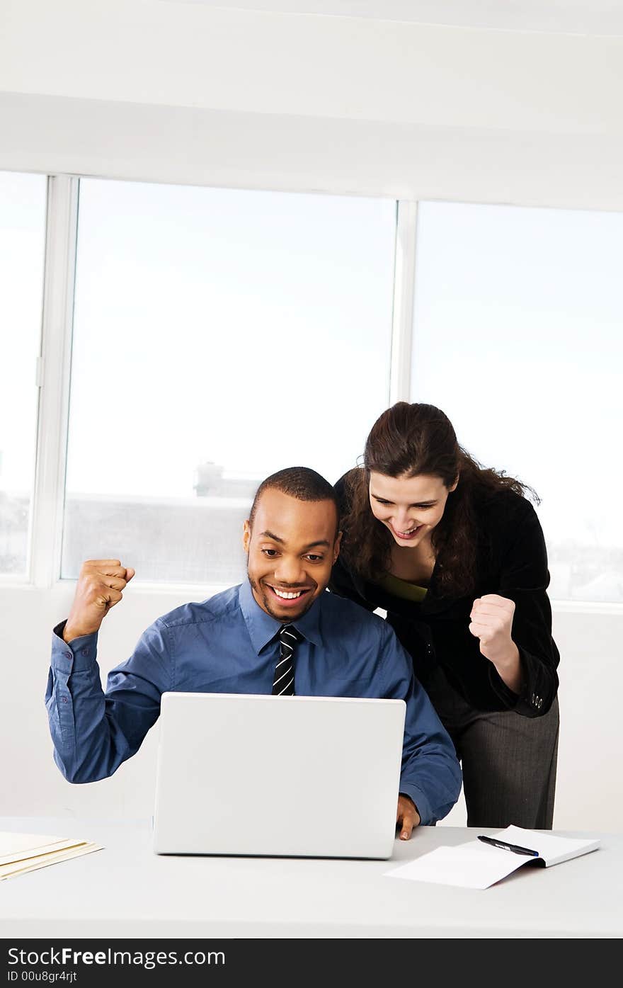 Male and female business partners in a window office. Male and female business partners in a window office