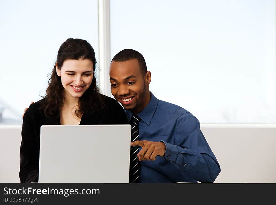 Male and female business partners in a window office. Male and female business partners in a window office