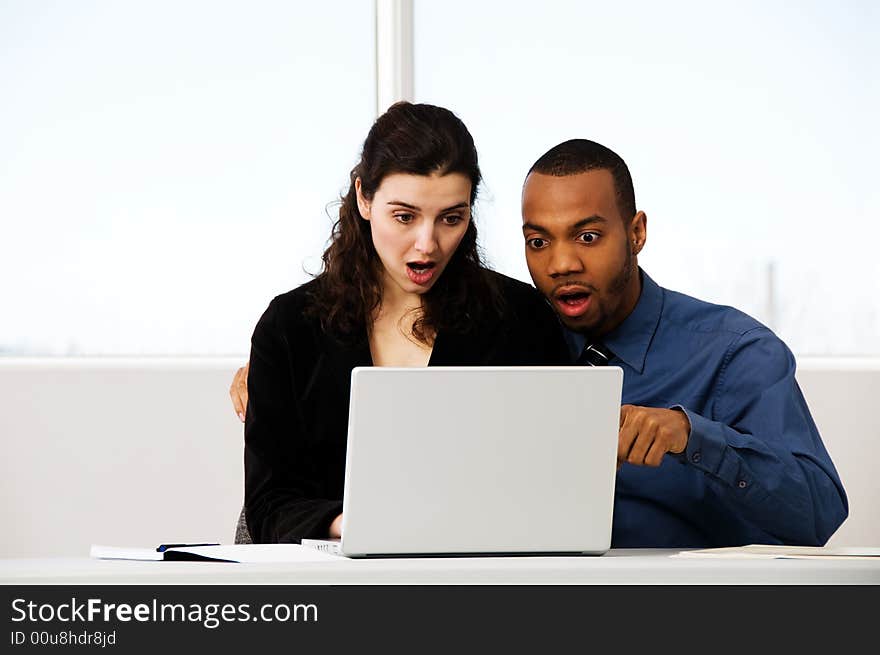 Male and female business partners in a window office. Male and female business partners in a window office