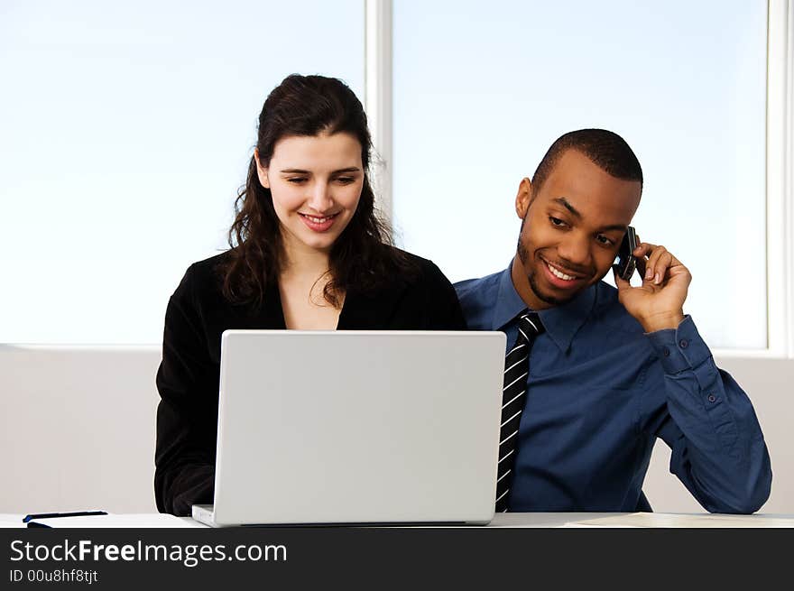 Male and female business partners in a window office. Male and female business partners in a window office