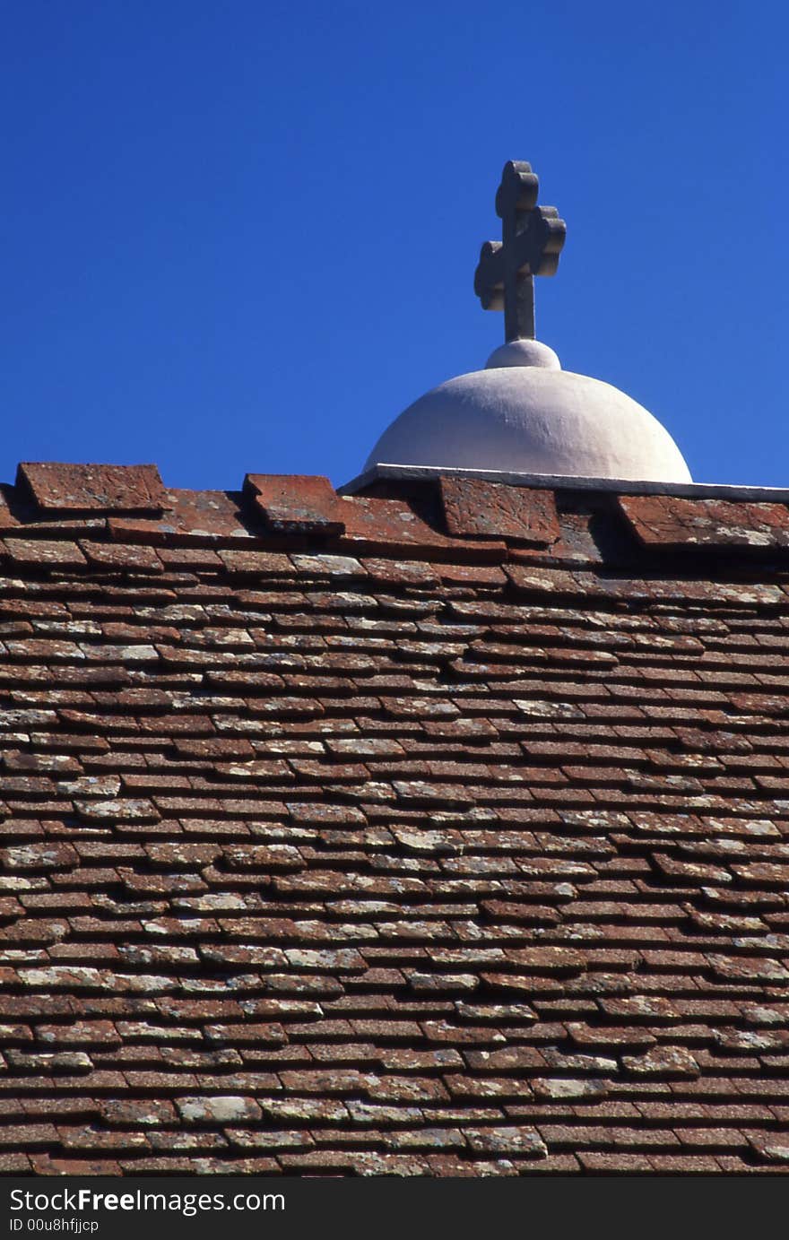 A simple frame with cross , roof and blue sky