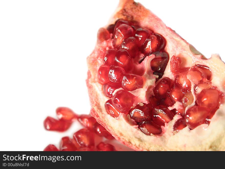 Pomegranate and kernels on a white background