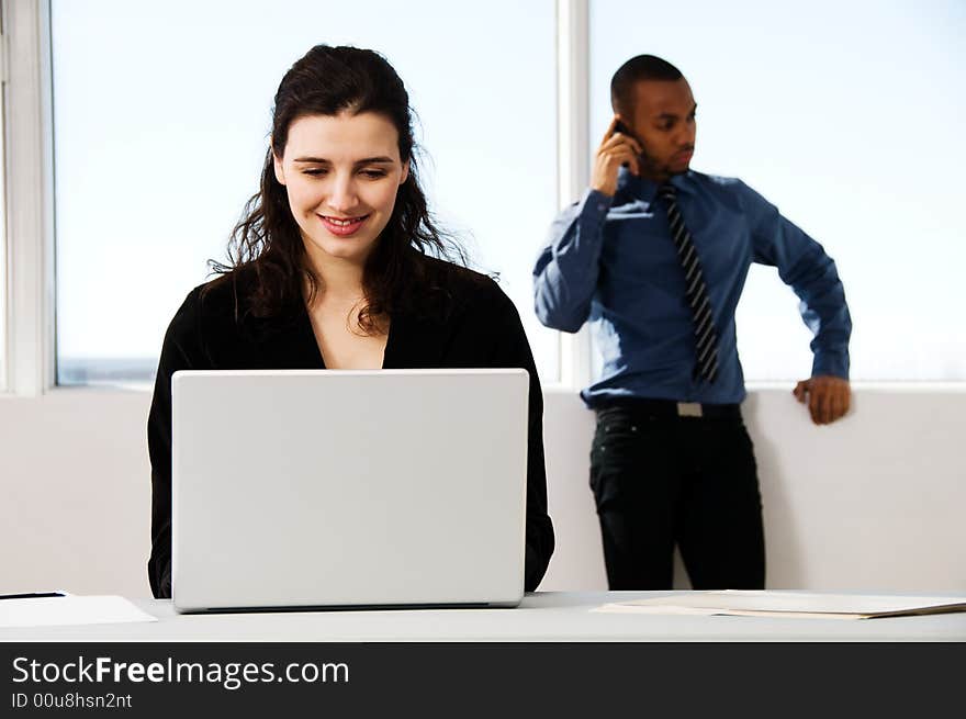 Male and female business partners in a window office. Male and female business partners in a window office