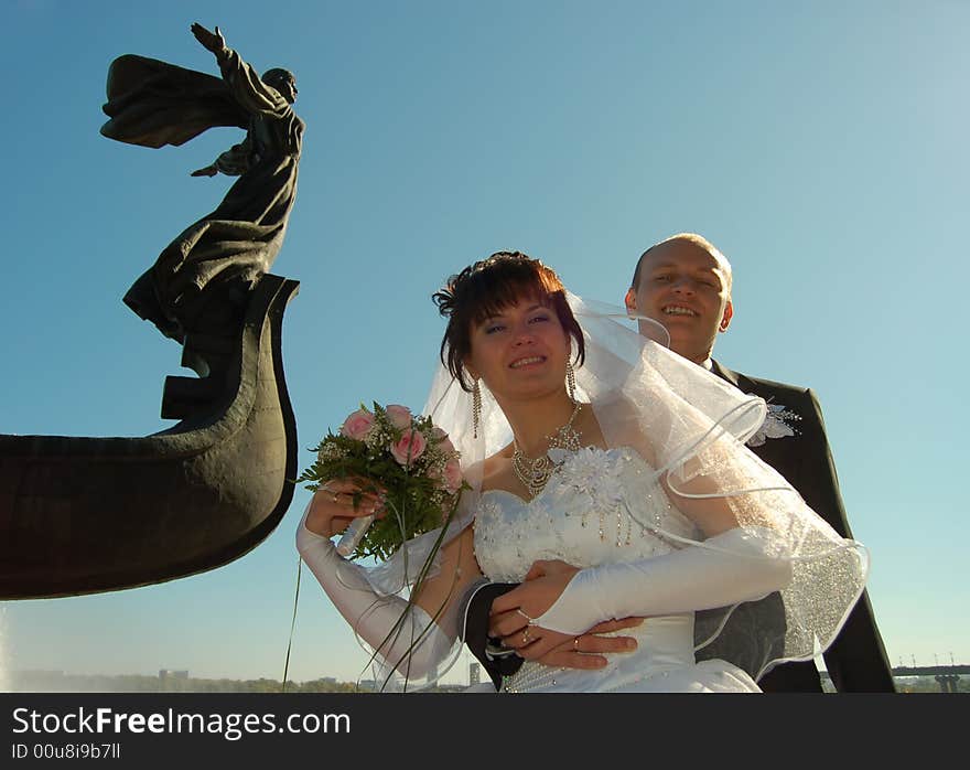 Newly wedded couple walking on the park