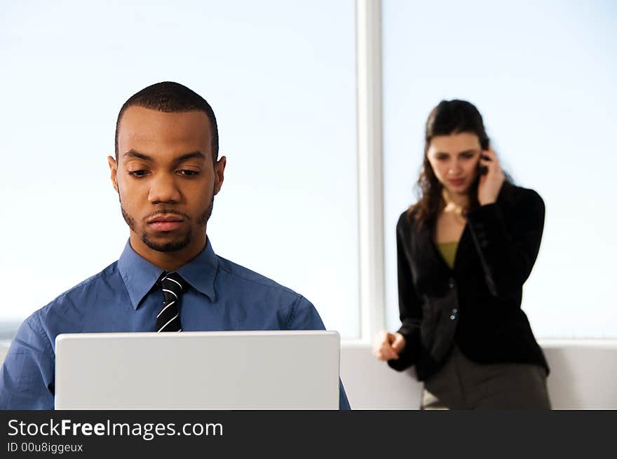 Male and female business partners in a window office. Male and female business partners in a window office