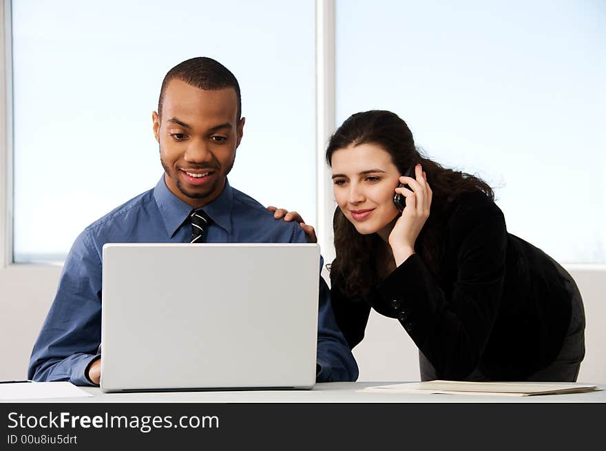 Male and female business partners in a window office. Male and female business partners in a window office