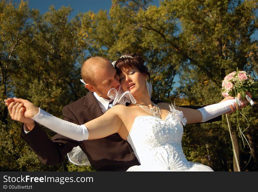 Portrait of the a newly wedded couple kissing