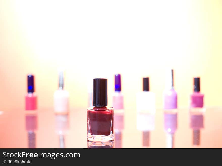 Group of different nail polishes on the sunshine background / copyspace