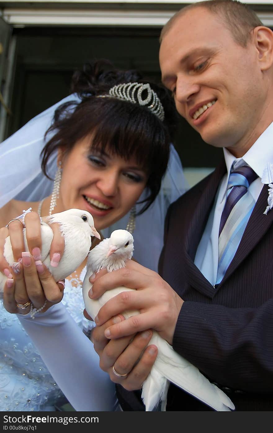 Newly wedded couple with doves