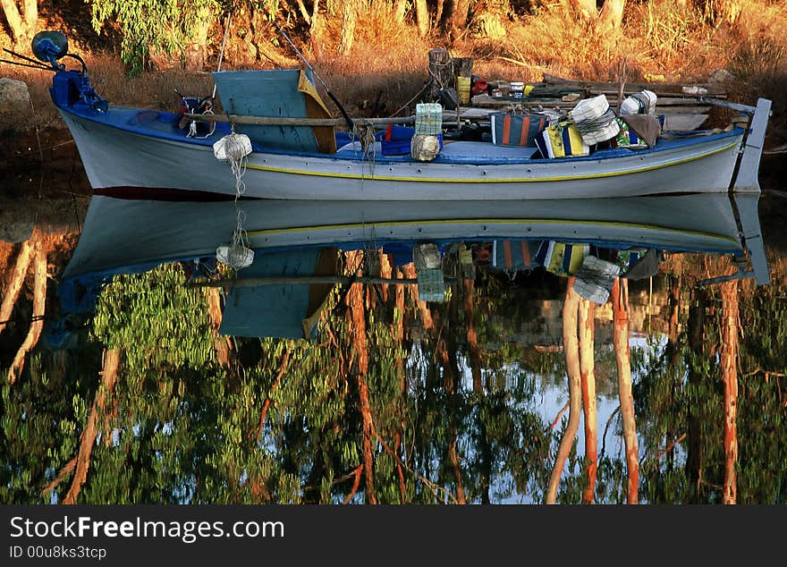 A reflection fishing boat in a river. A reflection fishing boat in a river