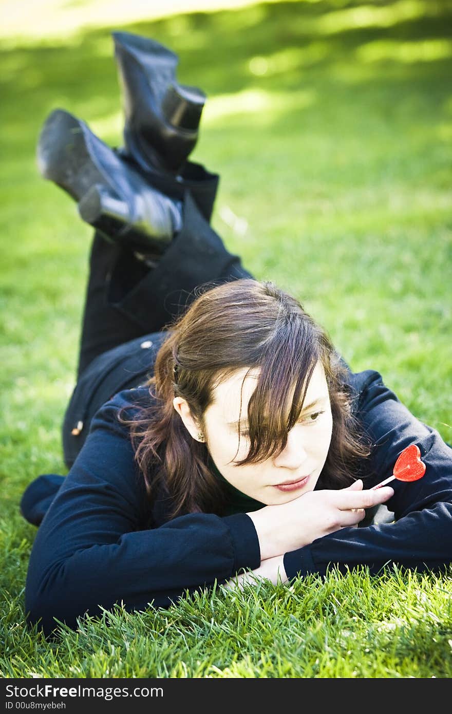 Young woman with red candy in her hands. Young woman with red candy in her hands