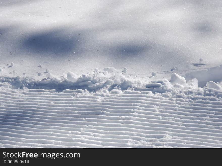 Parallel strips in the snow - in blue light