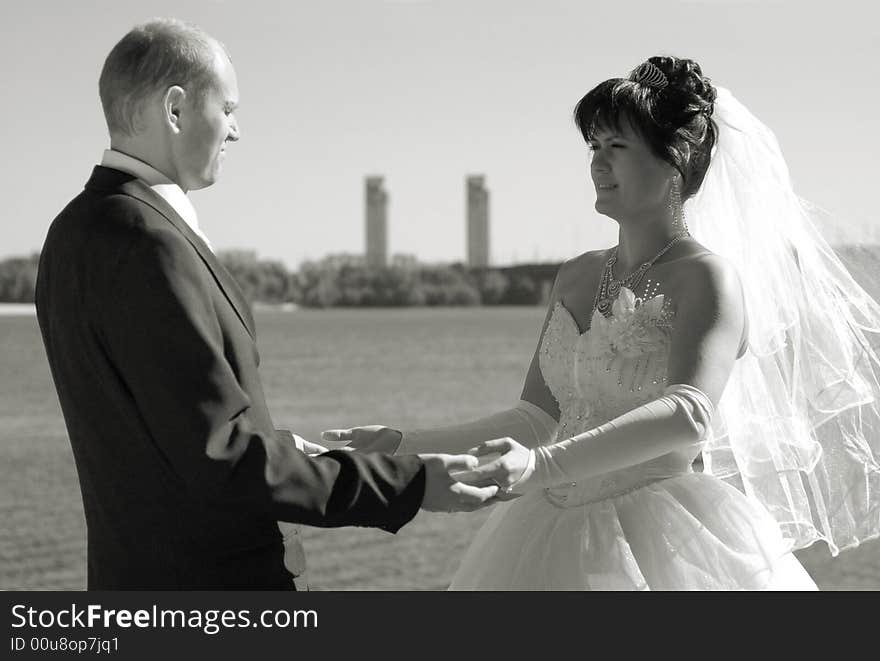 Newly wedded couple walking near the river