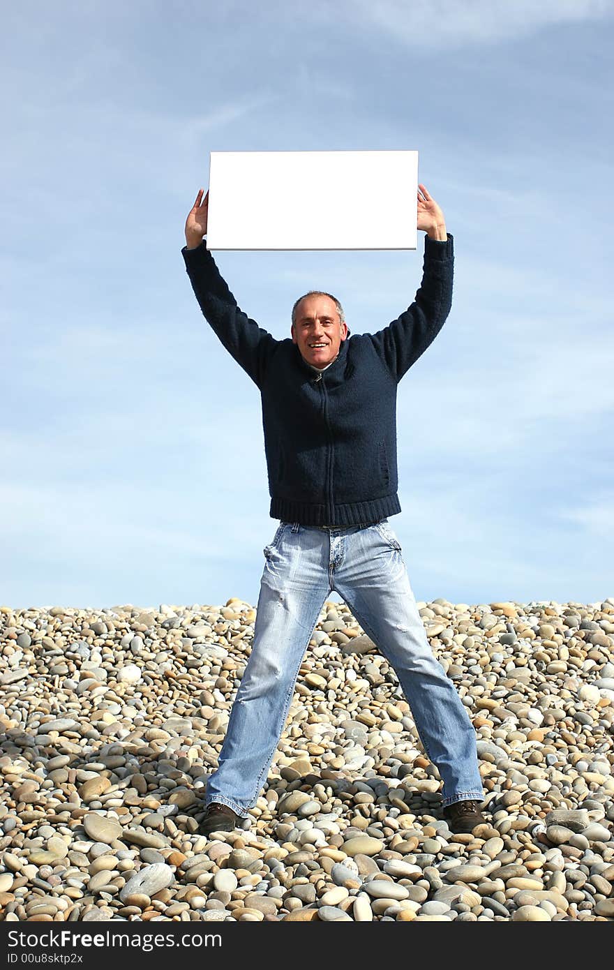 Young Man Holding White Card at the beach