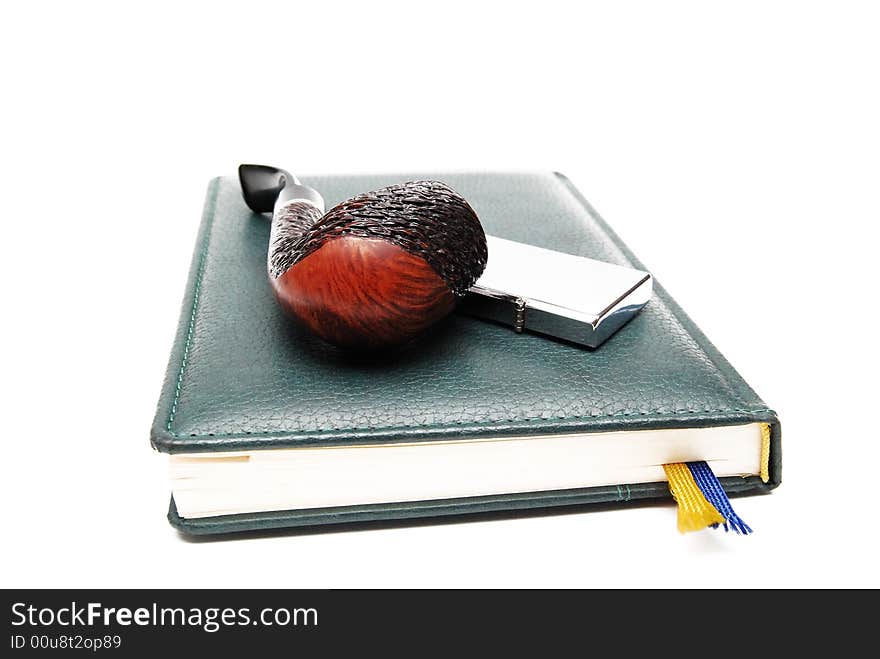 Diary and tobacco-pipe on a white background