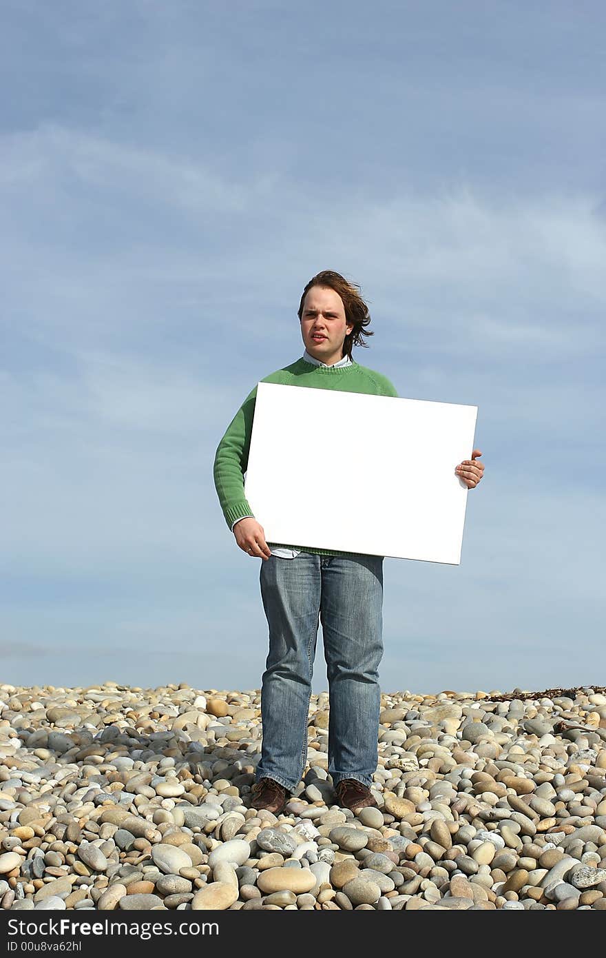 Young Man Holding White Card at the beach