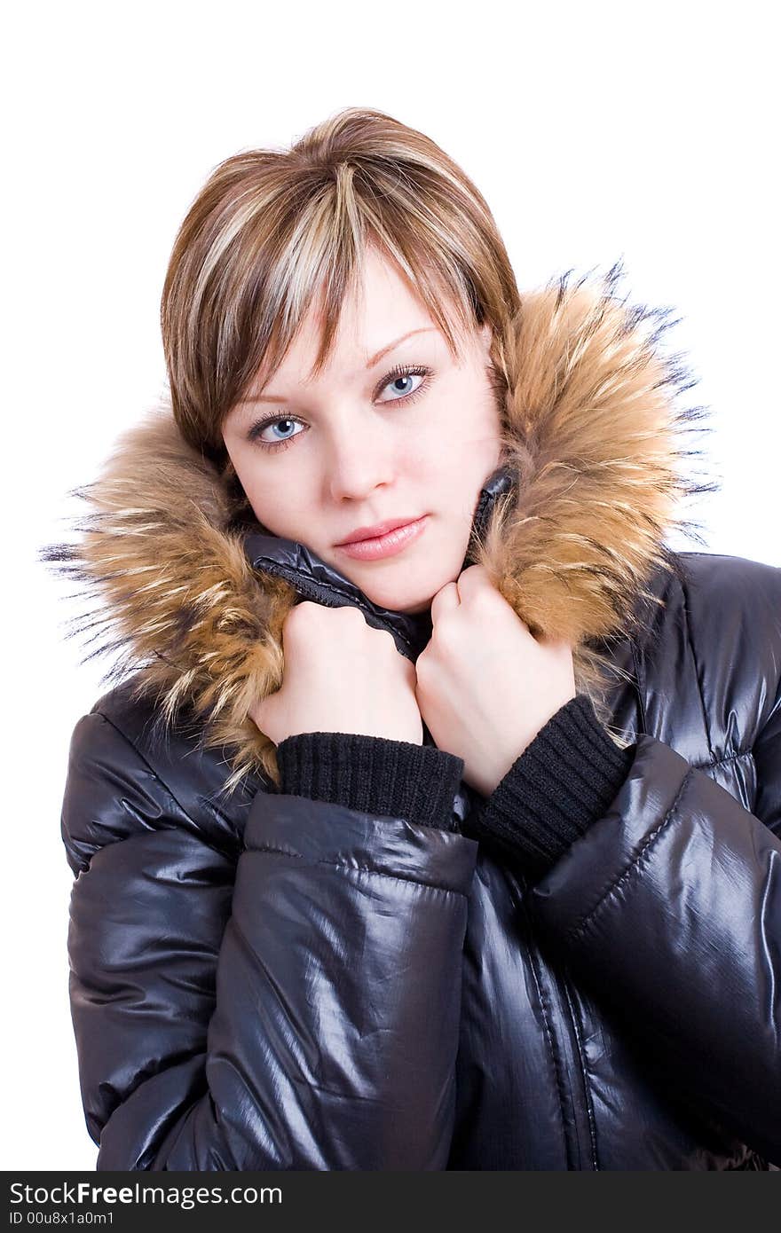 A congeal girl in a furry collar at the black winter jacket. A congeal girl in a furry collar at the black winter jacket