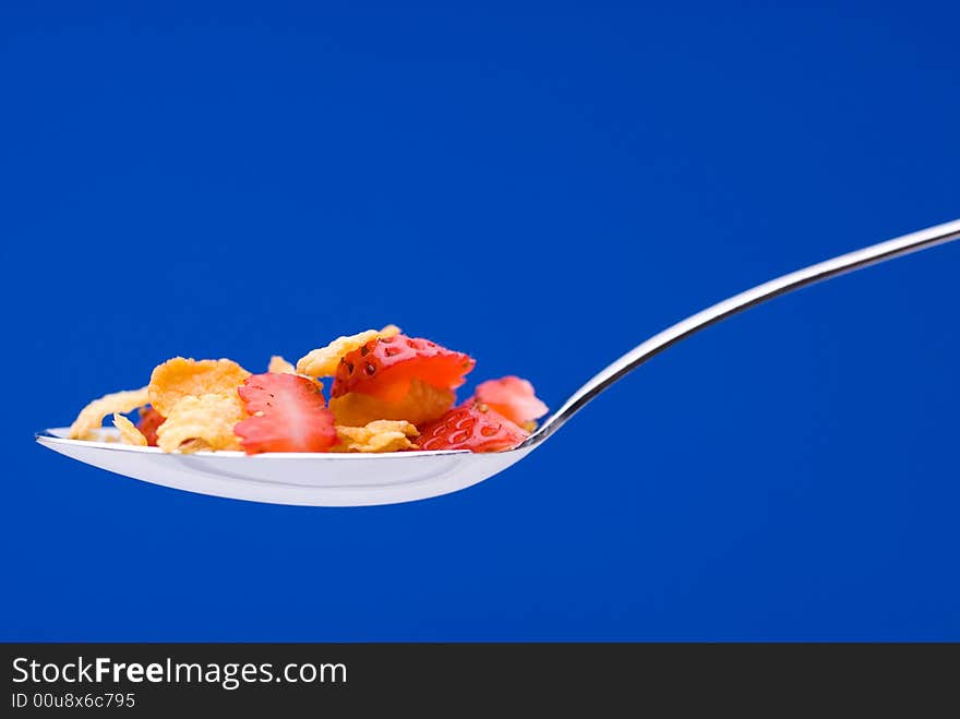 Cereal with strawberries on a spoon