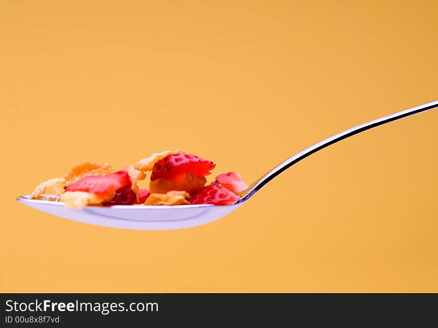 Cereal with strawberries on a spoon