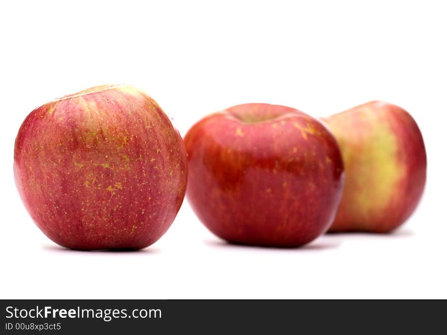 Fresh red apples on a white background with shallow focus. Fresh red apples on a white background with shallow focus