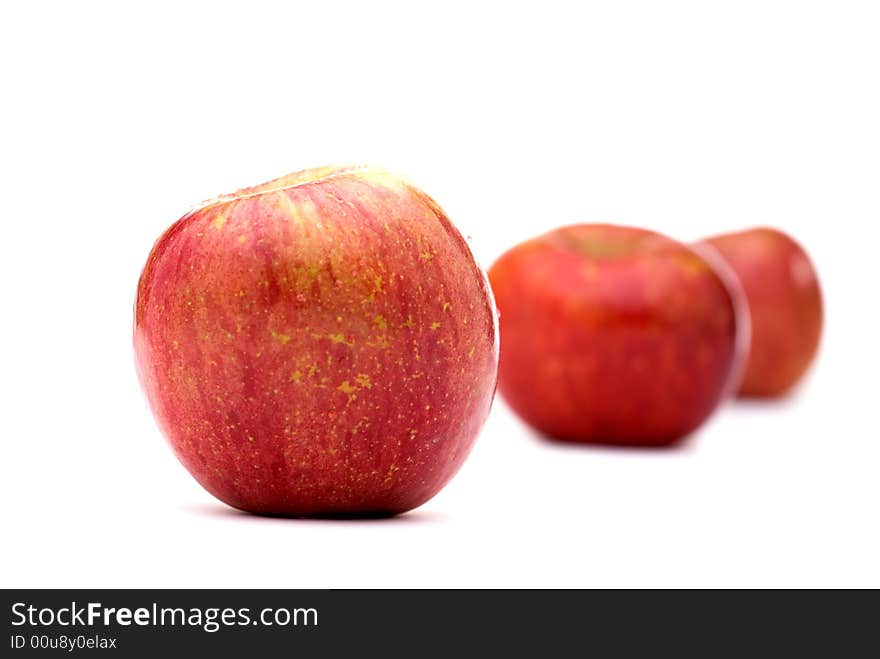 Fresh red apples on a white background with shallow focus. Fresh red apples on a white background with shallow focus