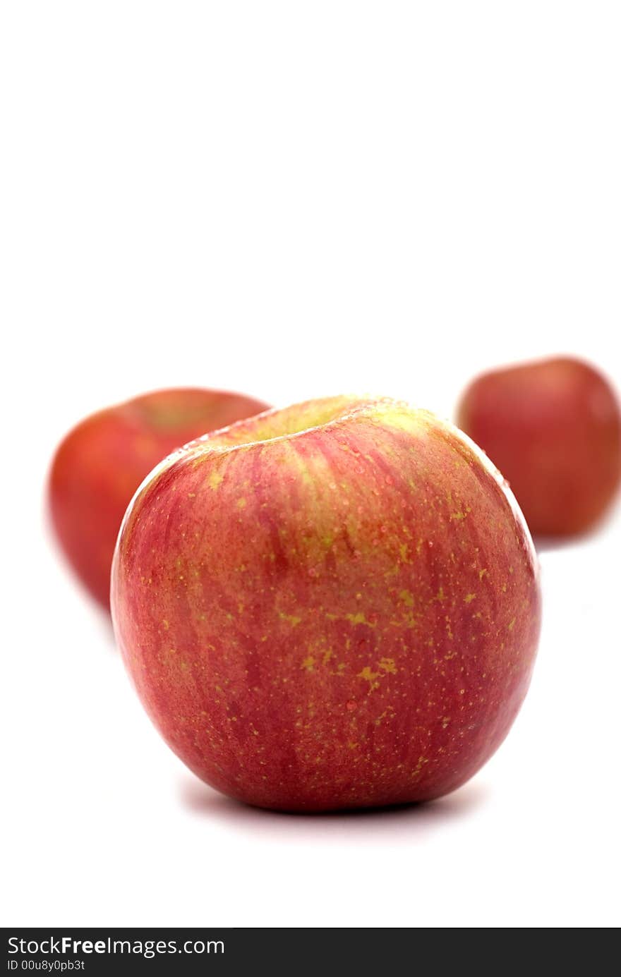 Fresh red apples on a white background with shallow focus. Fresh red apples on a white background with shallow focus