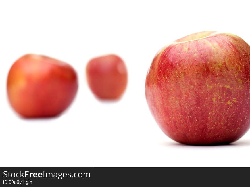 Fresh red apples on a white background with shallow focus. Fresh red apples on a white background with shallow focus