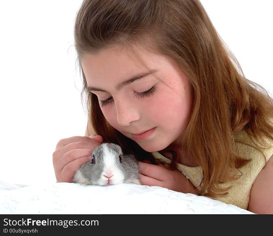 School aged girl petting soft gray bunny