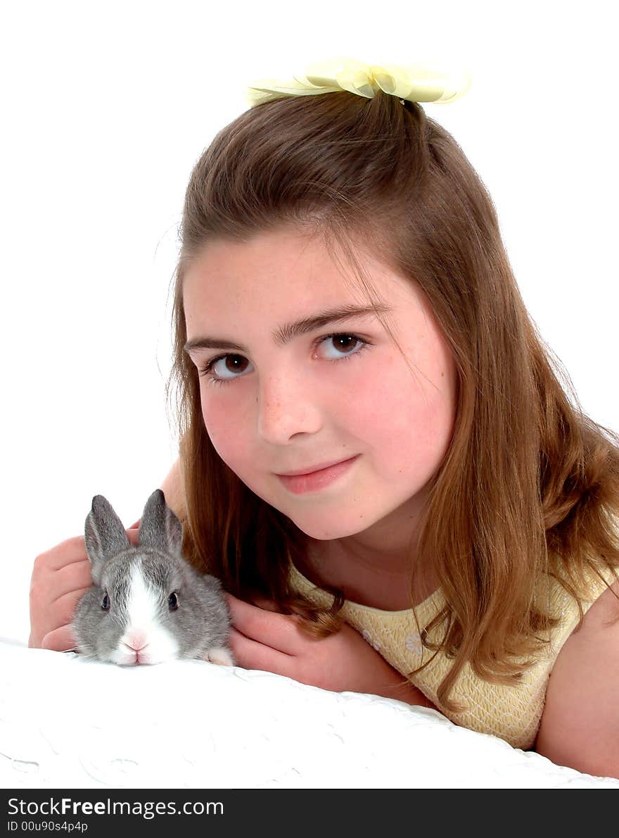 School aged girl gently petting soft gray bunny. School aged girl gently petting soft gray bunny