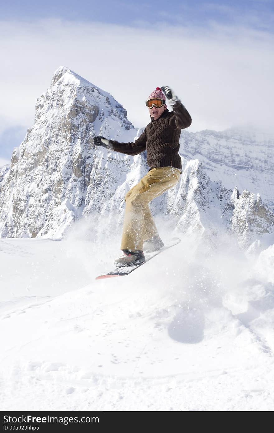 Snowboarder taking a jump in fresh snow