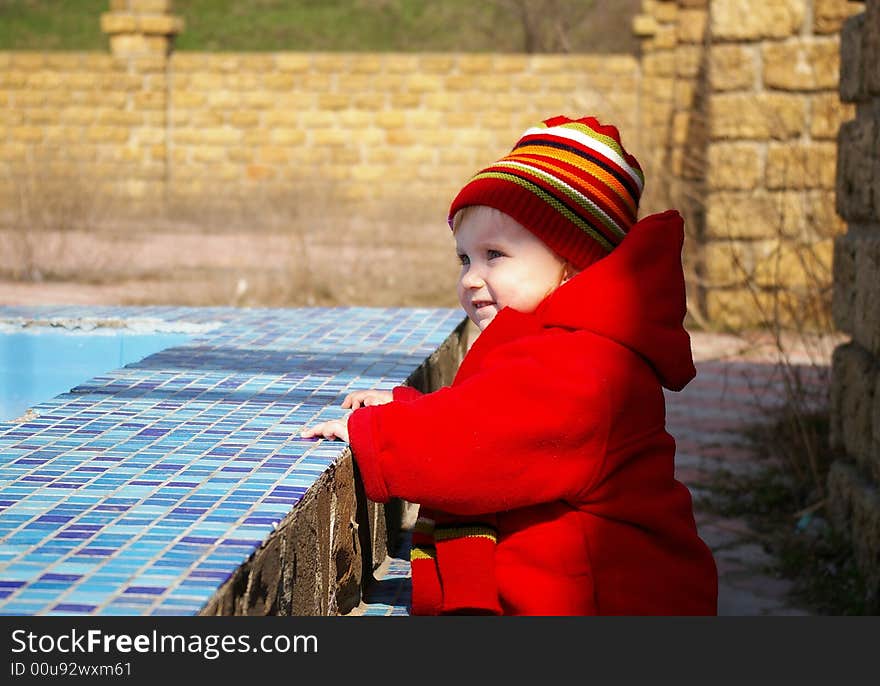 Little girl looks at the old pool