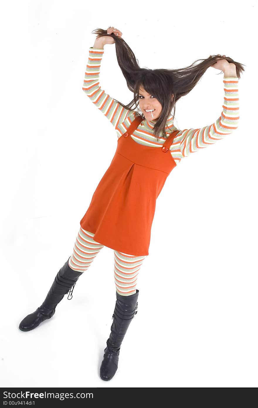 Young brunette girl in orange dress with candy. Young brunette girl in orange dress with candy.