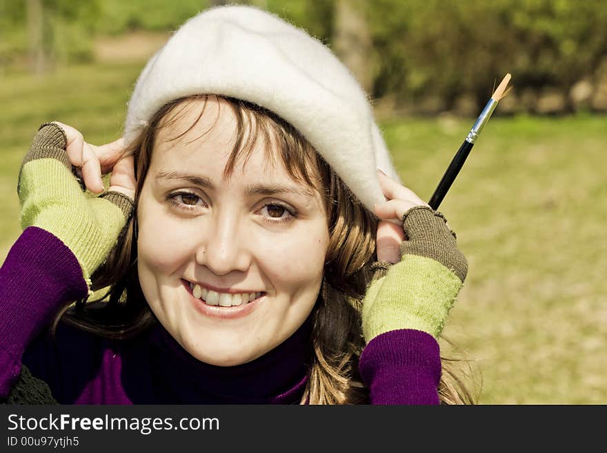 Smiling artist portrait with pen in her hand