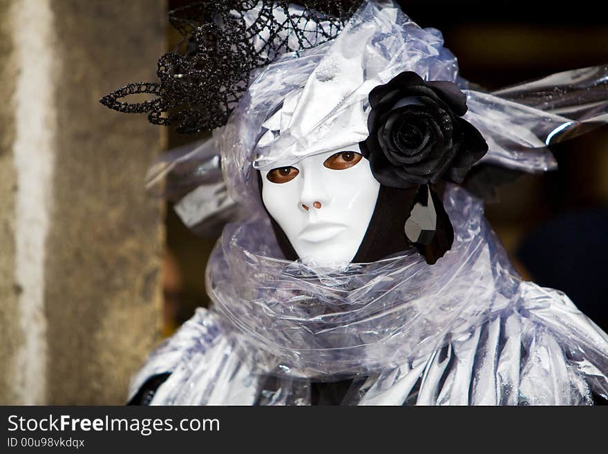 A man with a black rose and Venetian costume