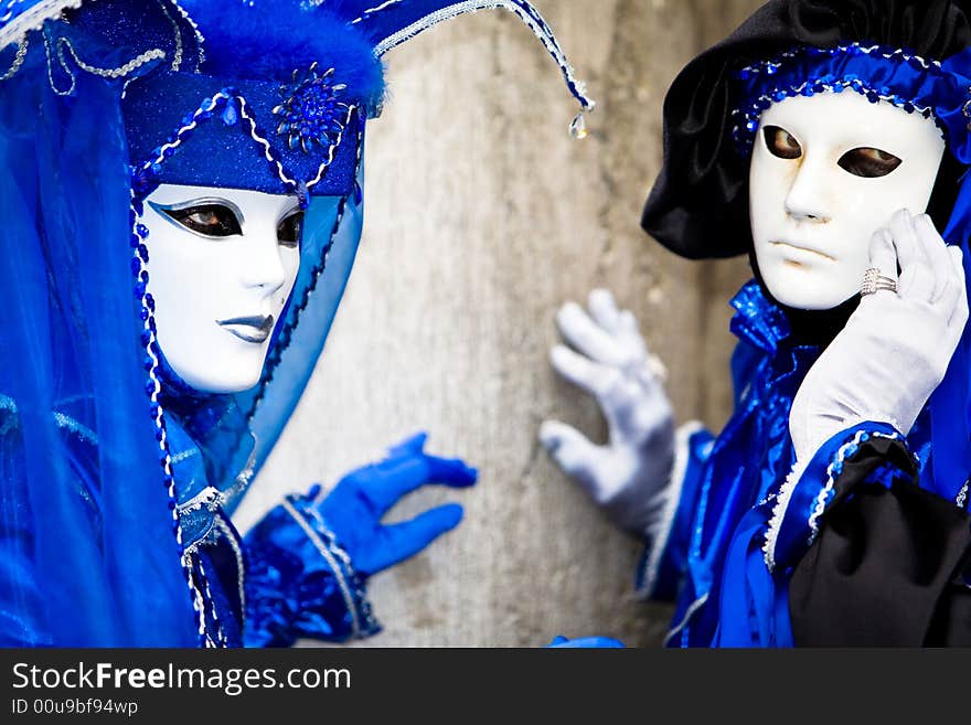 Two people in blue costumes at the Venice Carnival. Two people in blue costumes at the Venice Carnival