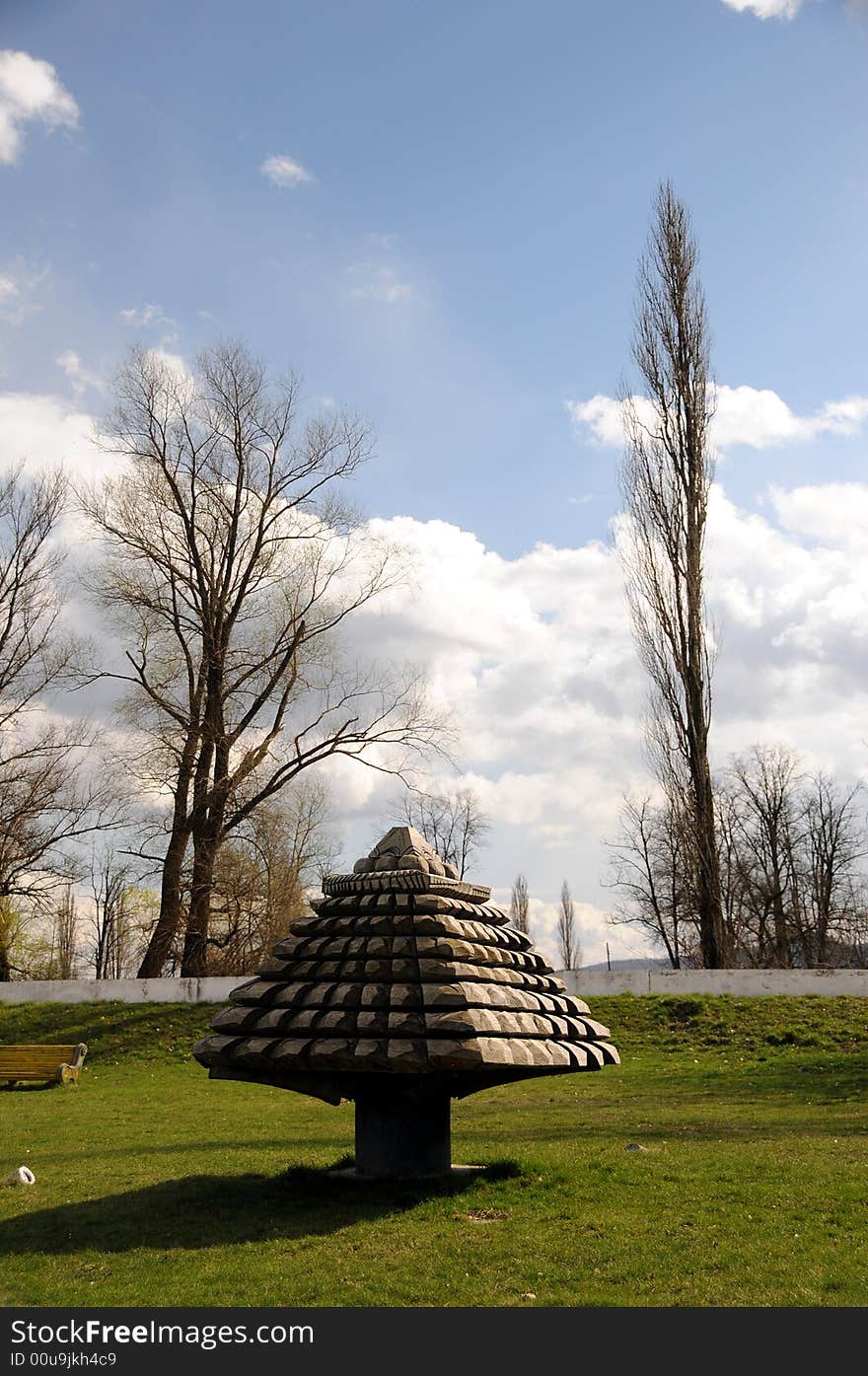 A view with an abstract wood sculpture outdoor. A view with an abstract wood sculpture outdoor