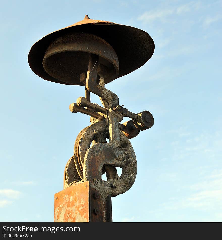 Old railroad alarm over a blue sky