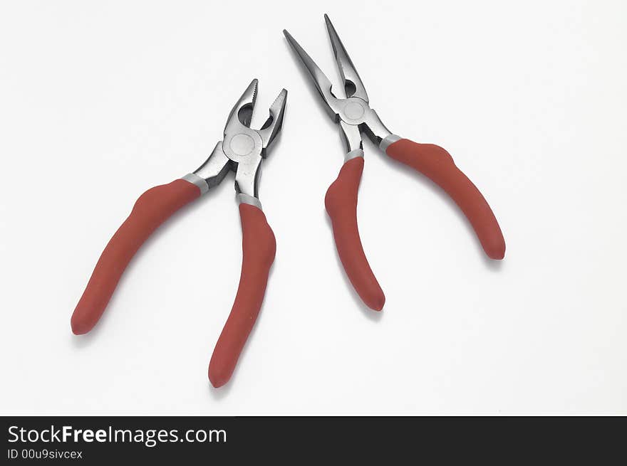 Pair of red handled pliers on white background. Pair of red handled pliers on white background