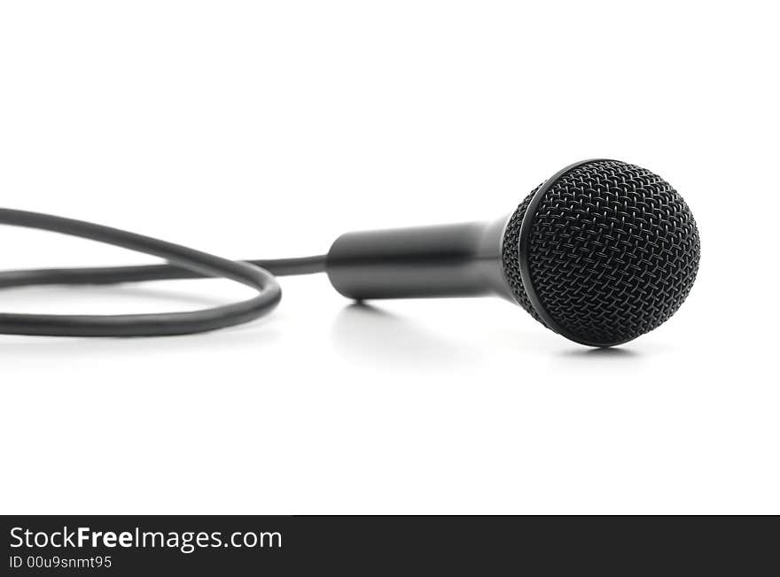 Classic black microphone lying on white background low angle