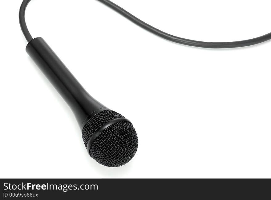 Classic black microphone lying on white from above