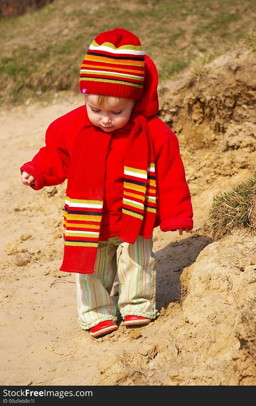 Little girl in the bright cap and  scarf