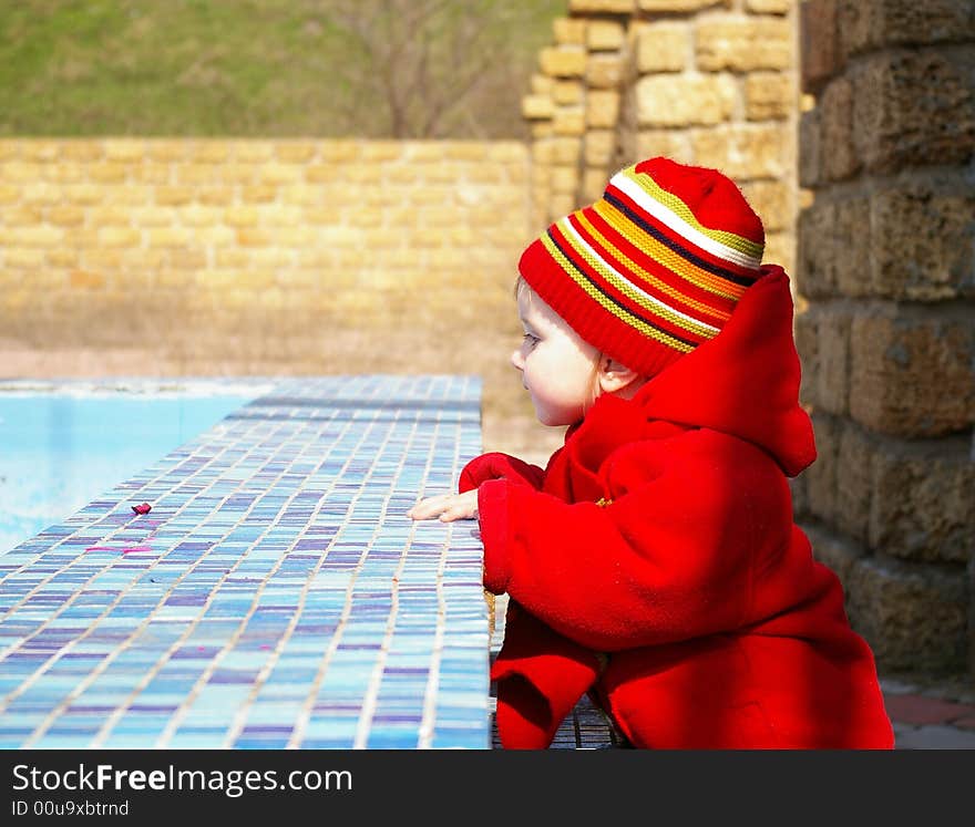 Little Girl Looks At The Thrown Pool